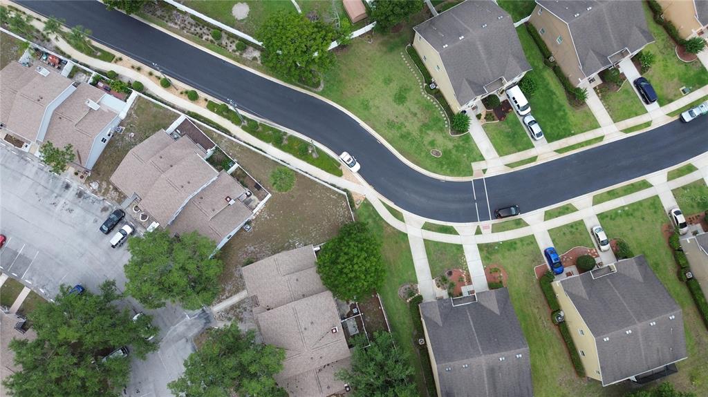 An aerial view shows a suburban neighborhood with houses, driveways, and a curved street — 1111 PETERSON PLACE, SANFORD, FL