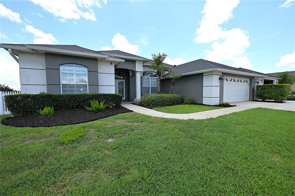 A single-story house with a gray exterior, white trim, and a two-car garage — 2618 HIGH RIDGE DRIVE, LAKELAND, FL