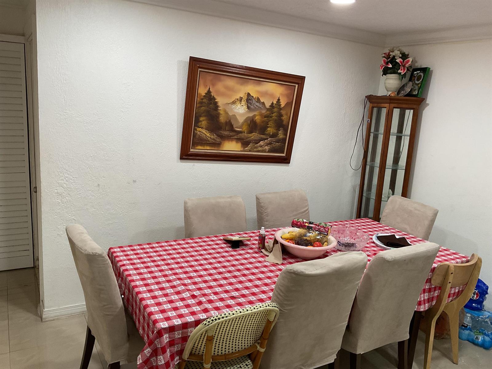 A dining room features a table with a red checkered cloth and surrounding chairs — 1433 NE 26th Court, Pompano Beach FL 33064, POMPANO BEACH, FL