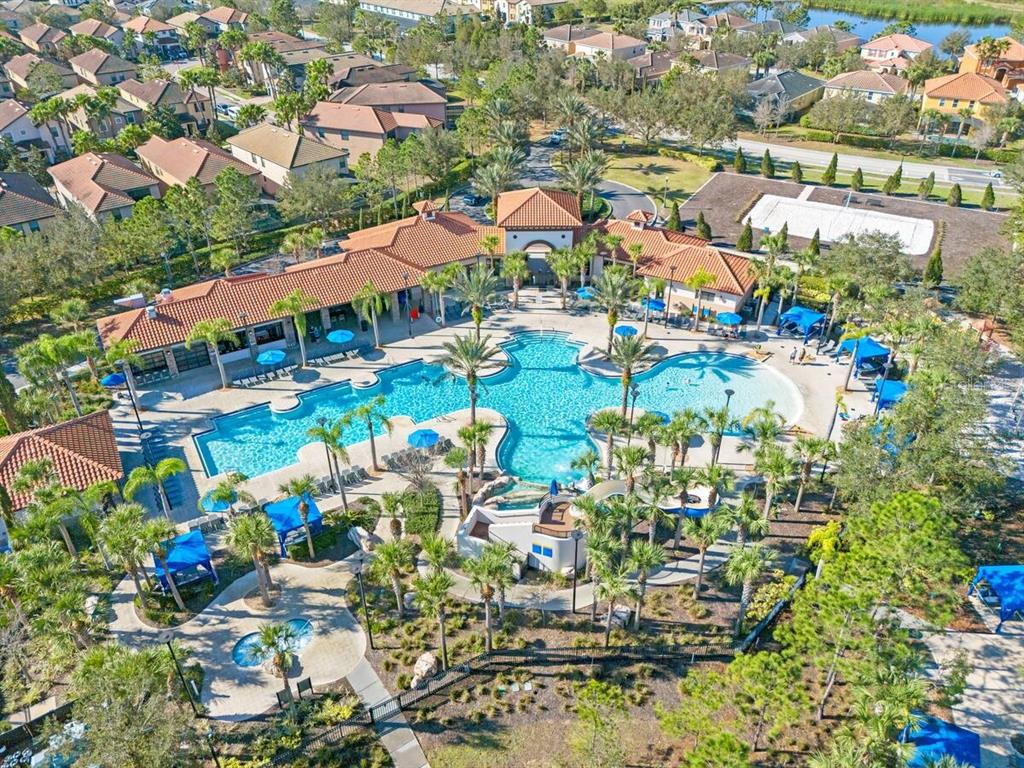 An aerial view of a community swimming pool complex surrounded by houses and landscaping — 5405 MISTY OAK CIRCLE, DAVENPORT, FL