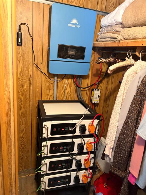 A solar power inverter and a stack of four lithium batteries are mounted in a closet — 13322 SW 95TH STREET, DUNNELLON, FL
