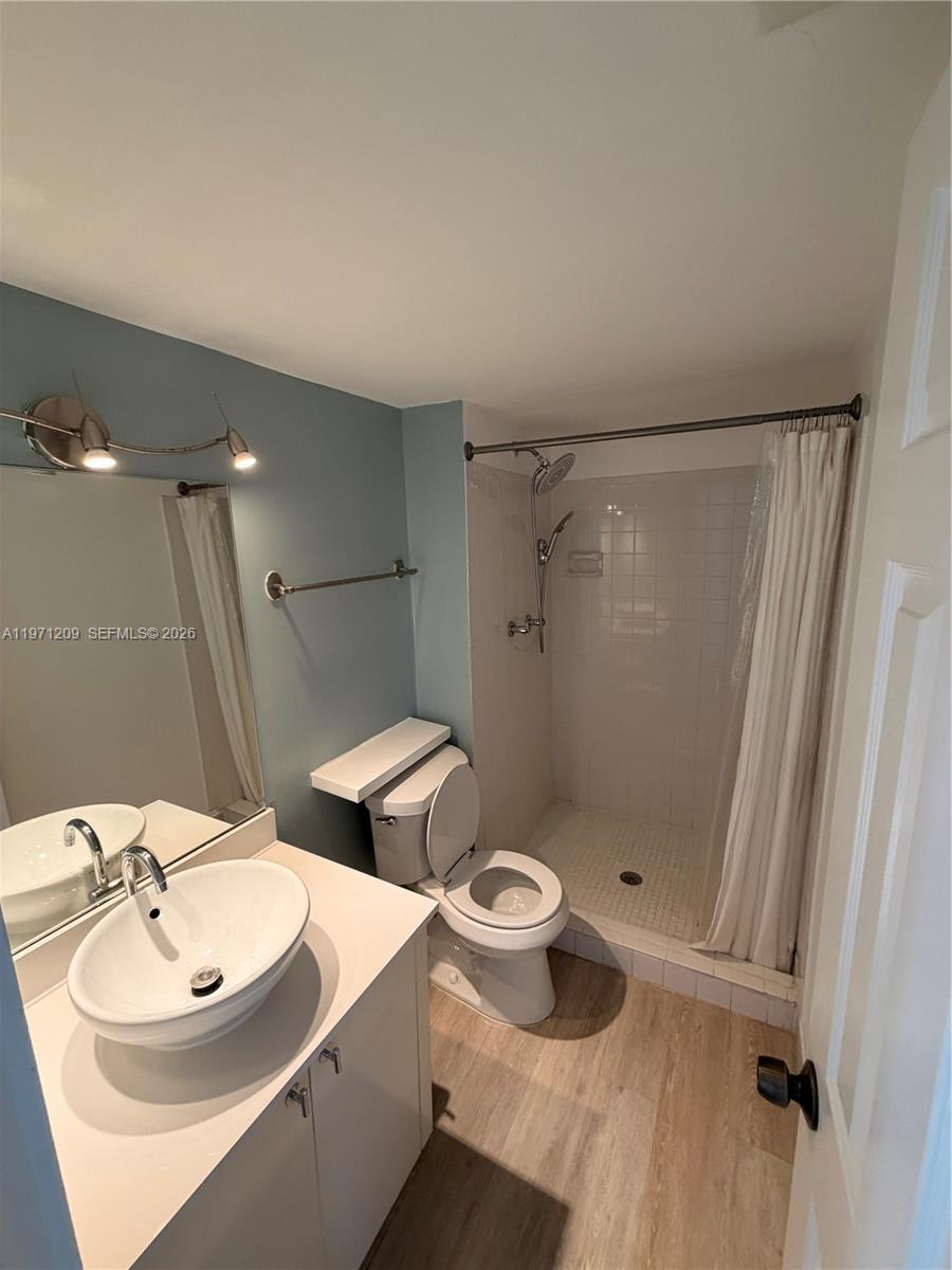 A bathroom features a vessel sink vanity, a toilet, and a tiled walk-in shower — 2350 NE 135th St # 503, North Miami FL 33181, NORTH MIAMI, FL
