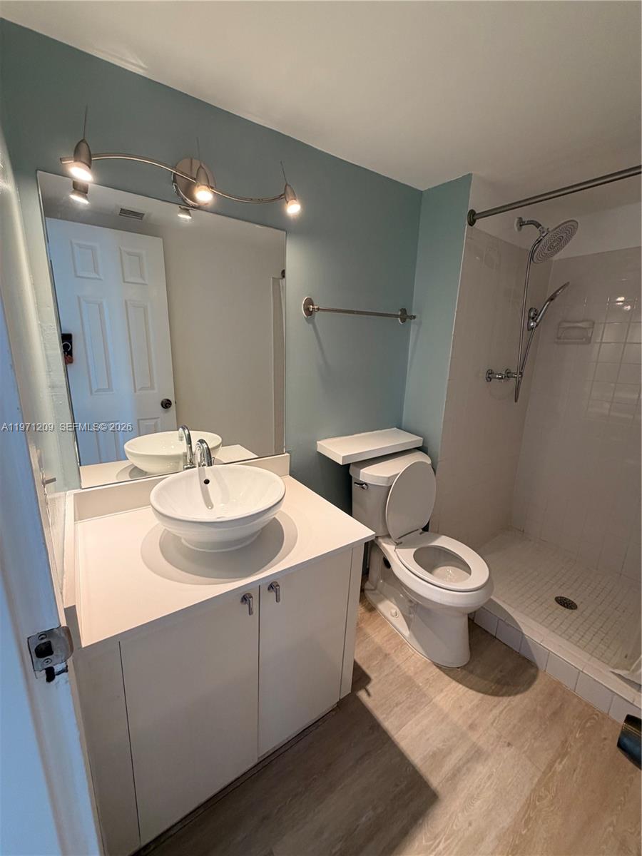 A bathroom features a vessel sink vanity, a toilet, and a tiled walk-in shower — 2350 NE 135th St # 503, North Miami FL 33181, NORTH MIAMI, FL