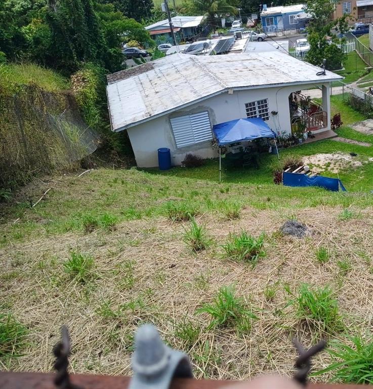 A high-angle view of a single-story house with a metal roof and blue canopy — 600 Pascual Valle CALLE PASCUAL VALLE CASTILLO, MAYAGUEZ, PR