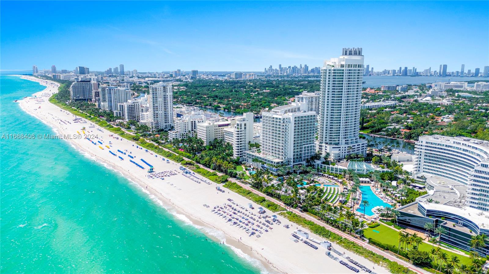 An aerial view of a sandy beach lined with high-rise hotels and resorts — 4391 Collins Ave, Miami Beach FL 33140, MIAMI BEACH, FL