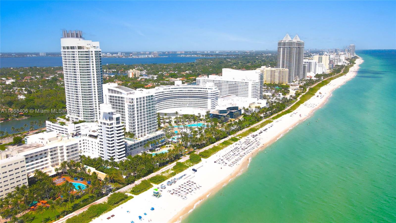 An aerial view shows high-rise buildings along a sandy beach bordering the turquoise ocean — 4391 Collins Ave, Miami Beach FL 33140, MIAMI BEACH, FL