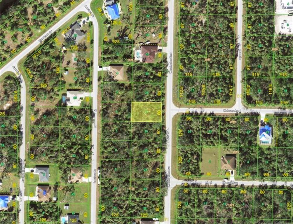 This is an aerial map showing a highlighted vacant residential lot among wooded properties — 243 WARRINGTON BOULEVARD, PORT CHARLOTTE, FL
