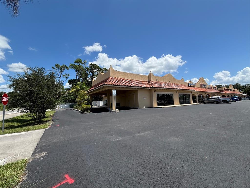 A commercial strip mall building with a tan stucco exterior and red tile roof — 2672-2686 TAMIAMI TRAIL UNIT 6B,7B, PORT CHARLOTTE, FL