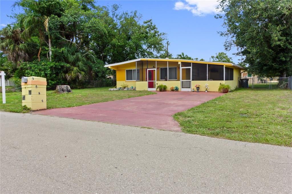 A yellow, single-story house with a screened-in front porch and a red driveway — 3741 BELL STREET, FORT MYERS, FL