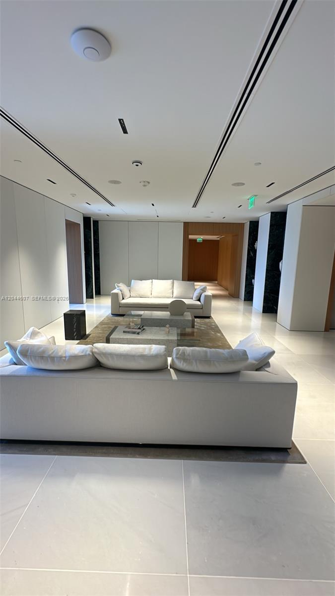 A modern living room features two white sofas facing each other on a large rug — 300 Biscayne Blvd Way # 1909, Miami FL 33131, MIAMI, FL
