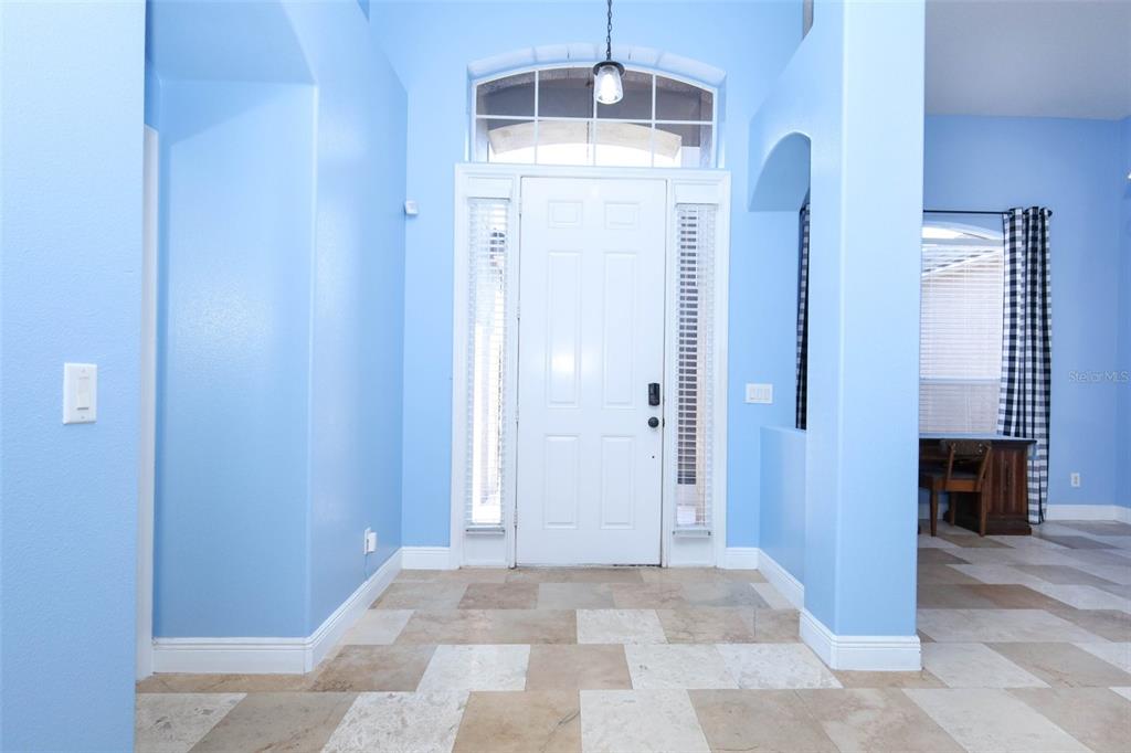 An entryway with light blue walls, tile flooring, and a white front door with sidelights — 1620 PARKGLEN CIRCLE, APOPKA, FL