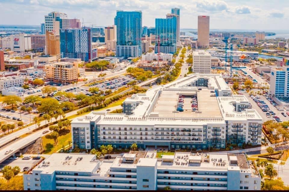 An aerial view of a modern apartment complex with a parking garage in a city — 201 W LAUREL STREET UNIT 712, TAMPA, FL