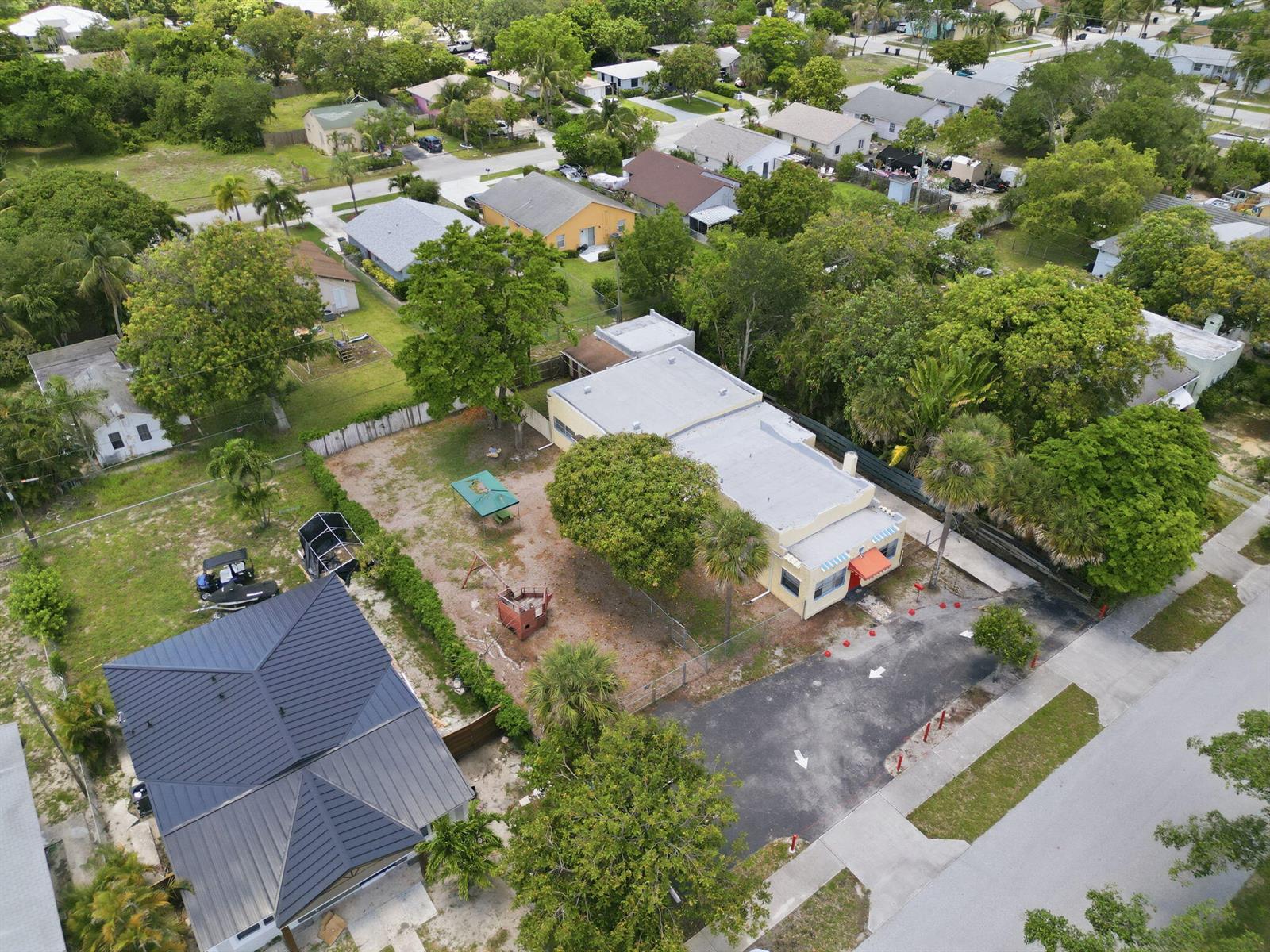 An aerial view shows a commercial building with a parking lot and a large yard — 216 SW 2nd Avenue, Delray Beach FL 33444, DELRAY BEACH, FL