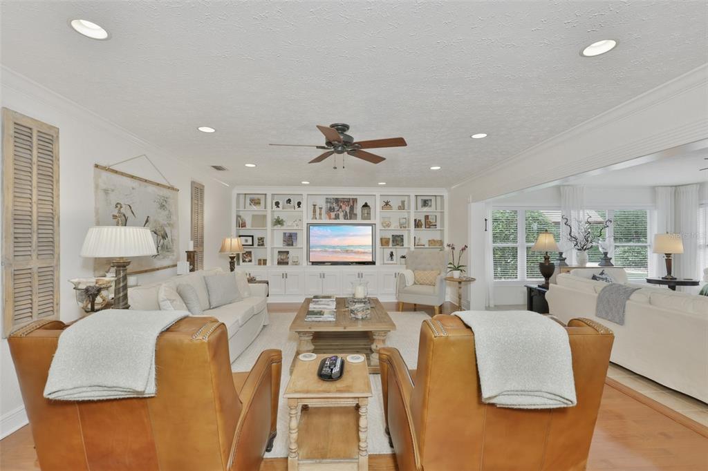 An aerial view shows a single-story suburban house with a gray roof and lawn — 412 STONEHAM DRIVE, SUN CITY CENTER, FL