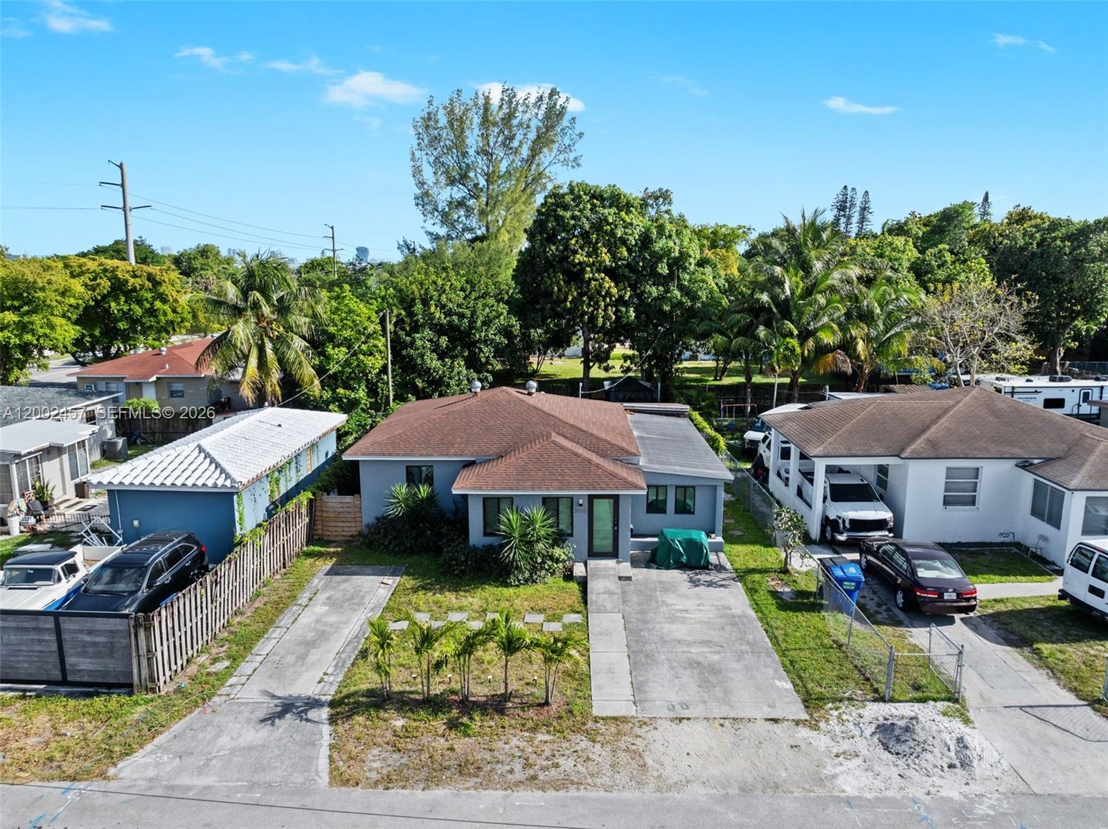 An aerial view shows a gray single-story house with a brown roof and two driveways — 2410 Jackson St, Hollywood FL 33020, HOLLYWOOD, FL