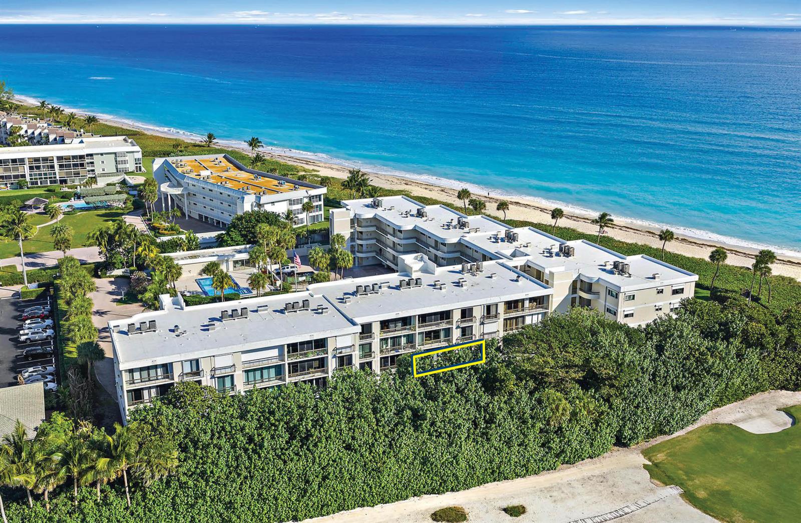 An aerial view of a multi-story beachfront condominium complex with a highlighted balcony unit — 70 Celestial Way # 108, Juno Beach FL 33408, JUNO BEACH, FL