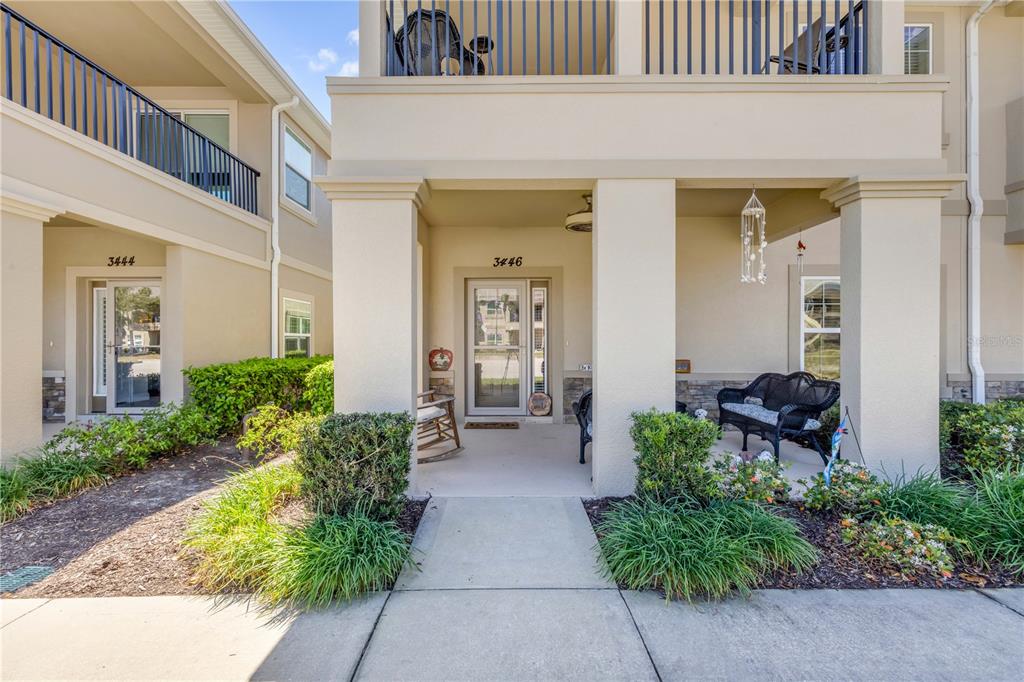 The exterior of a two-story residential building features two front entrances with covered porches — 3446 MEDICI BOULEVARD, NEW SMYRNA BEACH, FL