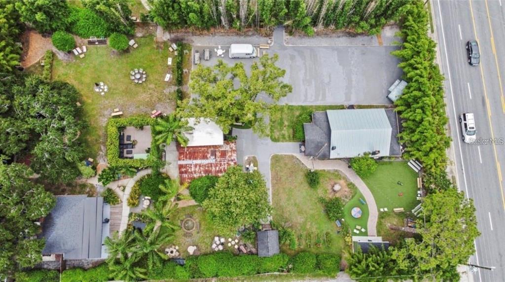 An aerial view shows a property with multiple buildings, landscaped grounds, and a parking area — 4421 EDGEWATER DRIVE, ORLANDO, FL