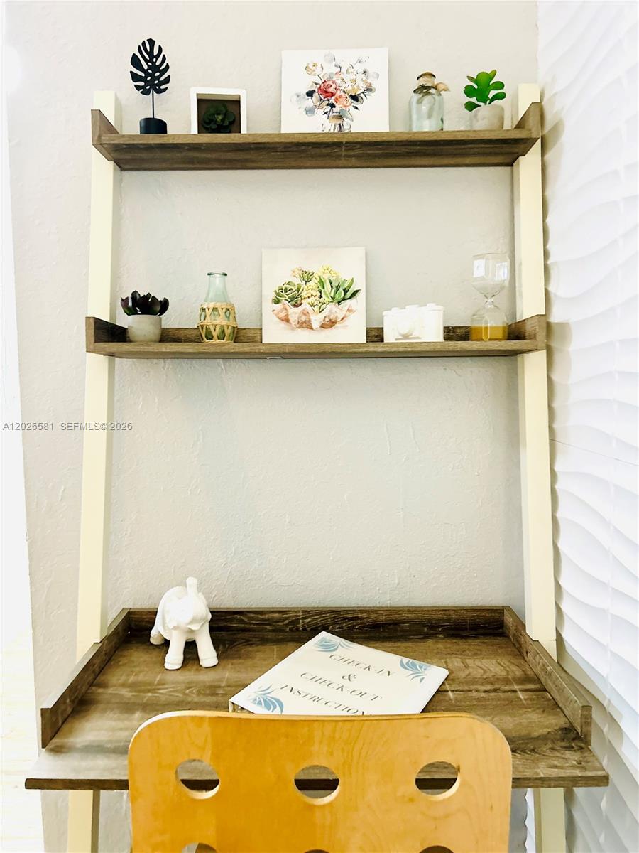 A wooden desk with two shelves above sits against a wall with white blinds — 1011 NW 7th Ave # 1011, Miami FL 33136, MIAMI, FL