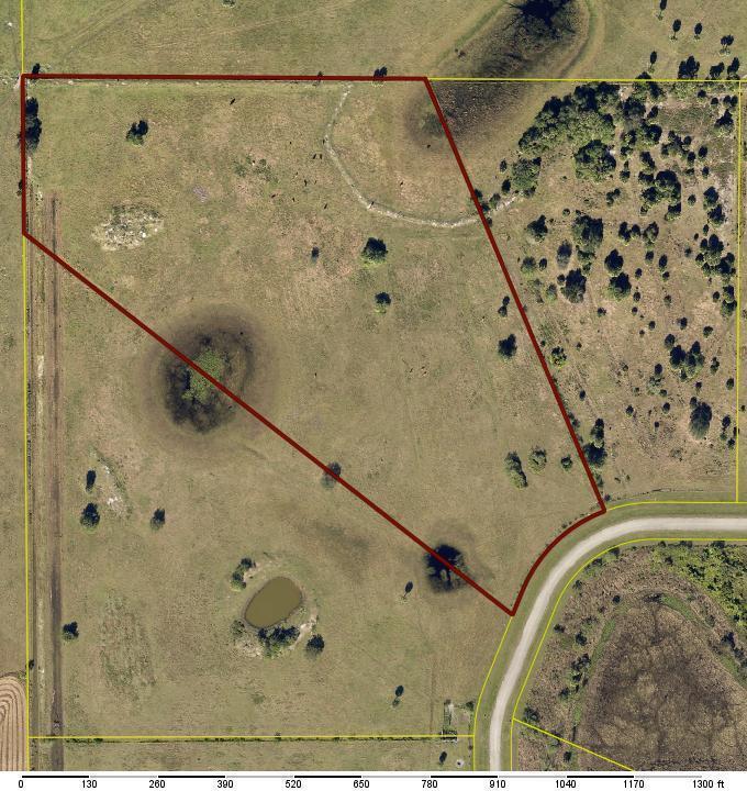 An aerial view shows a large, irregularly shaped plot of land outlined in red — 6572 SE 26th Trail, Okeechobee FL 34974, OKEECHOBEE, FL