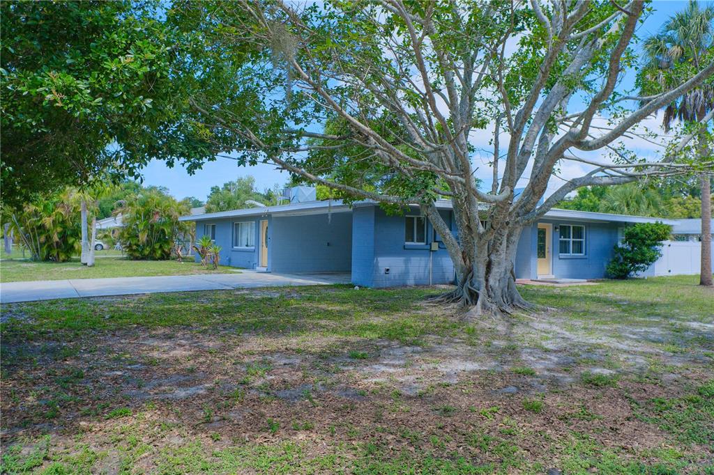 A single-story blue house with a flat roof, a carport, and a concrete driveway — 993 GARY STREET UNIT A & B, SARASOTA, FL