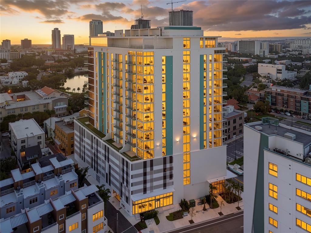 An aerial view of a modern high-rise apartment building at sunset in a city — 777 3RD AVENUE N UNIT 1104, ST PETERSBURG, FL