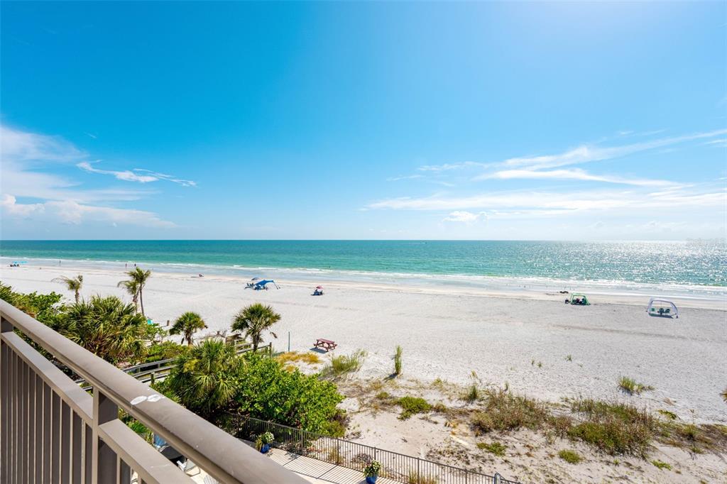 A view of a sandy beach and the ocean from a balcony with railings — 19700 GULF BOULEVARD UNIT 403, INDIAN SHORES, FL