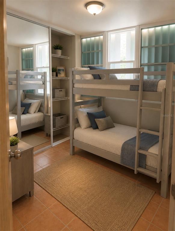 A bedroom features a wooden bunk bed, a mirrored closet, and tile flooring — 5015 PUNTA TUNA UNIT 401, MAUNABO, PR