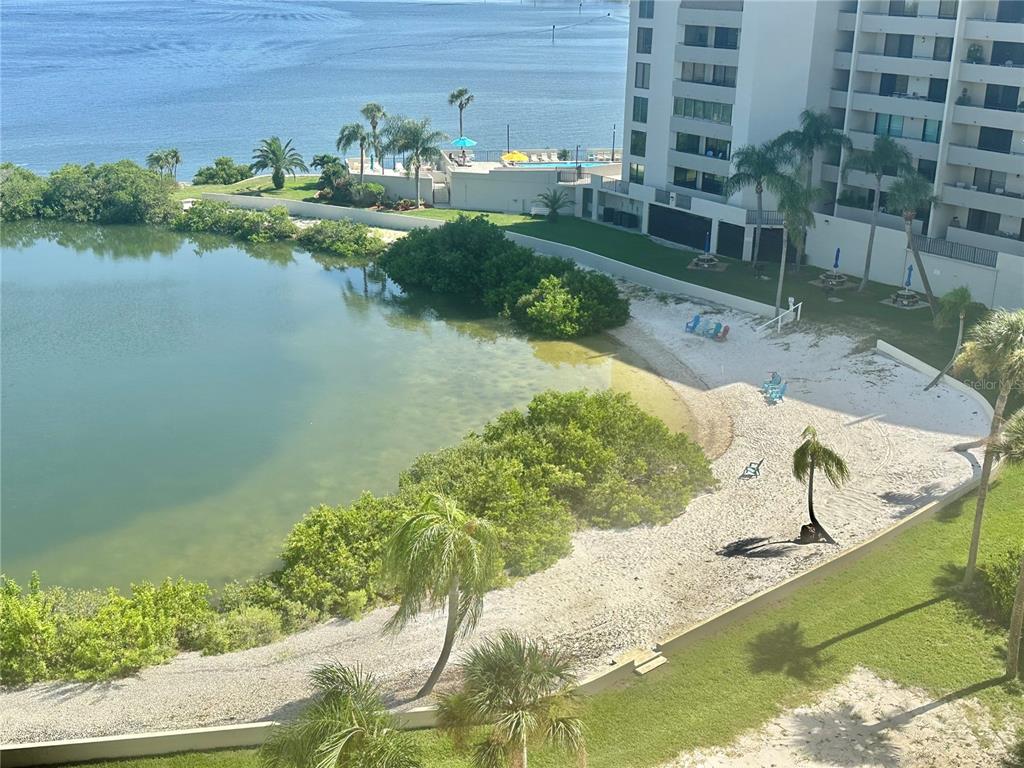An elevated view shows a sandy beach area, mangroves, and a building near water — 6009 SEA RANCH DRIVE UNIT 707, HUDSON, FL