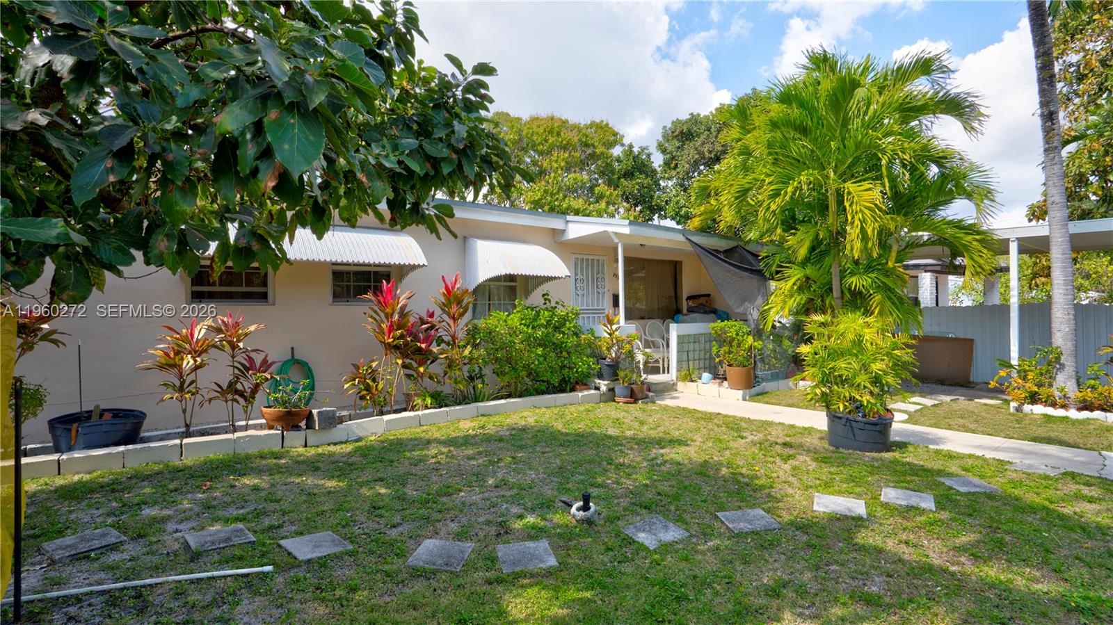 A single-story house features a front yard with a lawn, landscaping, and a paved walkway — 15700 NE 15th Pl, North Miami Beach FL 33162, NORTH MIAMI BEACH, FL