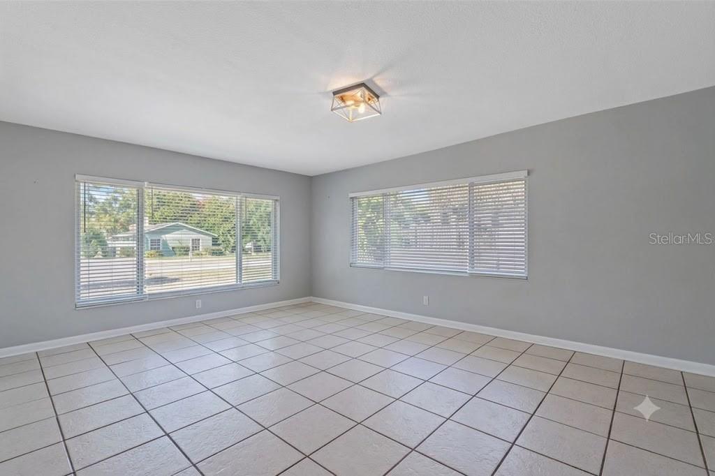 A kitchen with wood cabinets, stainless steel appliances, beige countertops, and a ceiling fan — 605 S FLORIDA AVENUE, TARPON SPRINGS, FL