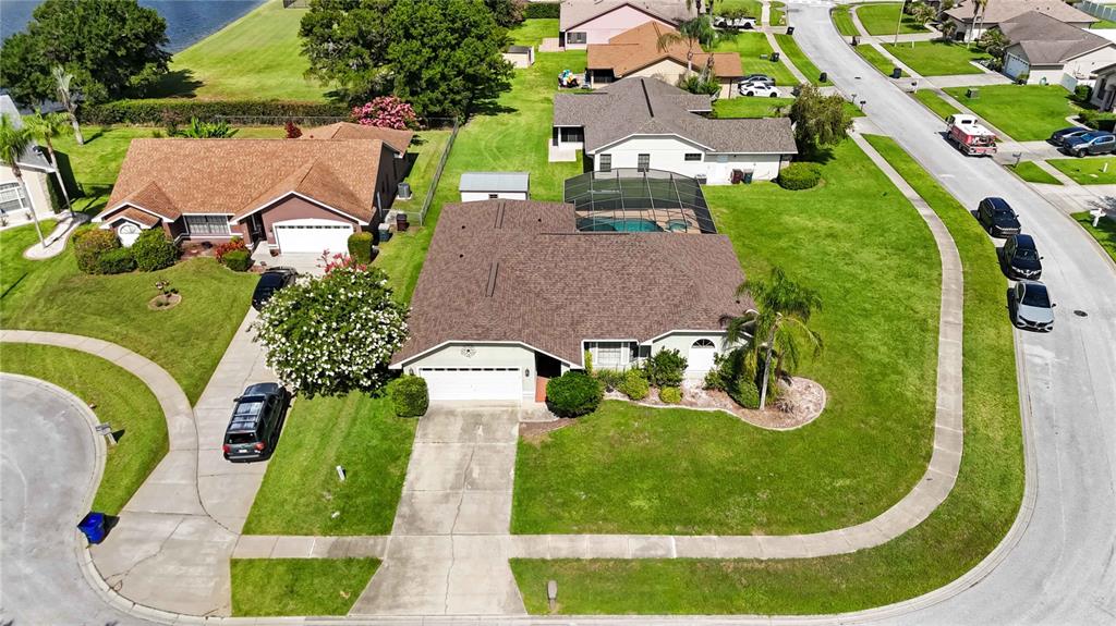 An aerial view shows a suburban house with a pool enclosure and a corner lot — 2207 DEATA COURT, ST CLOUD, FL
