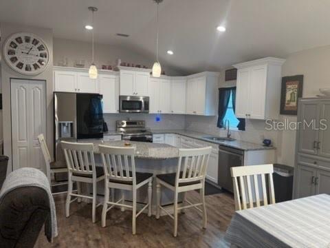 A single-story house with a beige stucco exterior, a two-car garage, and a large lawn — 12244 SE 86TH COURT, BELLEVIEW, FL
