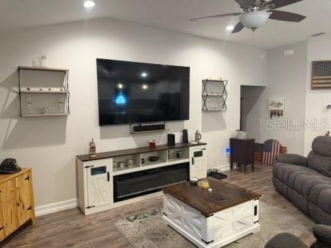 A single-story house with a white garage door, beige stucco siding, and a gray roof — 12244 SE 86TH COURT, BELLEVIEW, FL