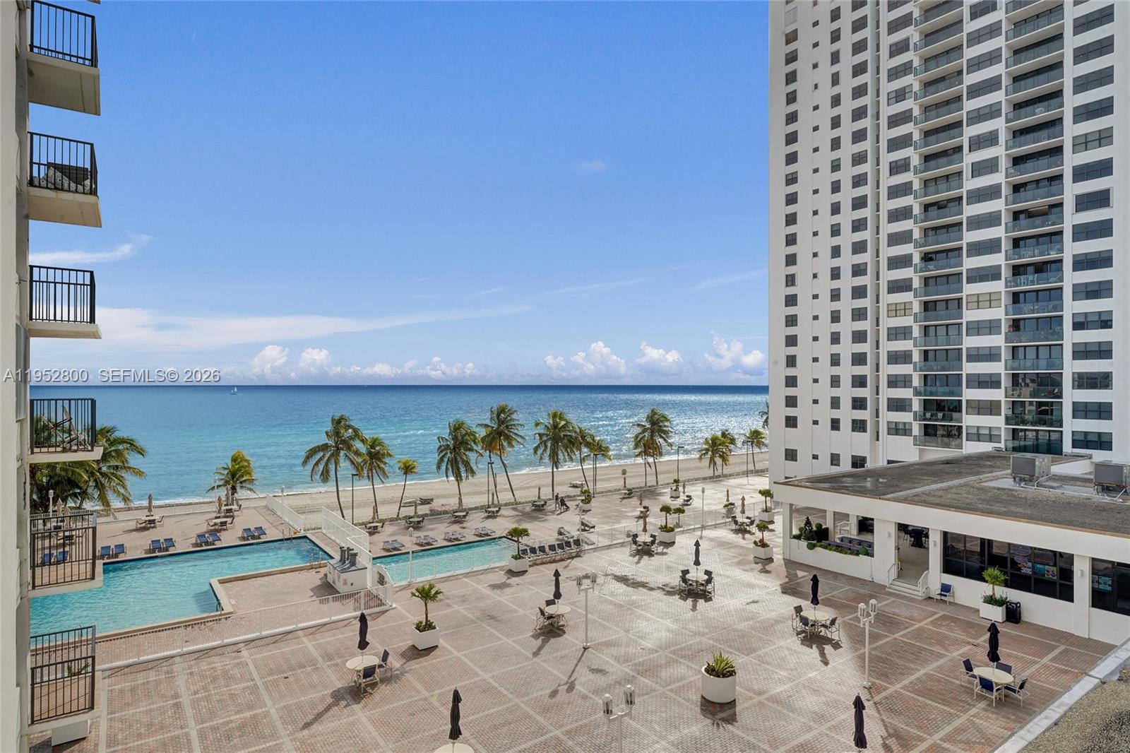 An elevated view shows a pool deck and patio area overlooking the ocean and beach — 2201 S Ocean Dr # 608, Hollywood FL 33019, HOLLYWOOD, FL