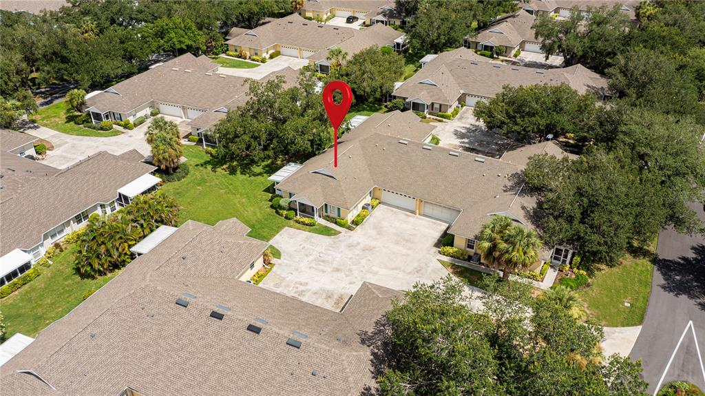 An aerial view shows a residential complex with a red location pin on a building — 1554 RED OAK LANE, PORT CHARLOTTE, FL
