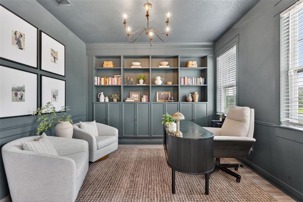 A home office features dark gray walls, built-in shelving, two armchairs, and a curved desk — 1112 PEARL TREE ROAD, DELTONA, FL