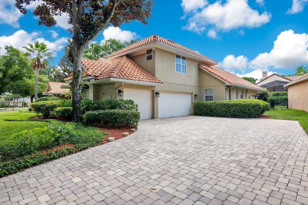 A two-story house with a tiled roof, two-car garage, and a paved driveway — 7718 DEBEAUBIEN DRIVE, ORLANDO, FL