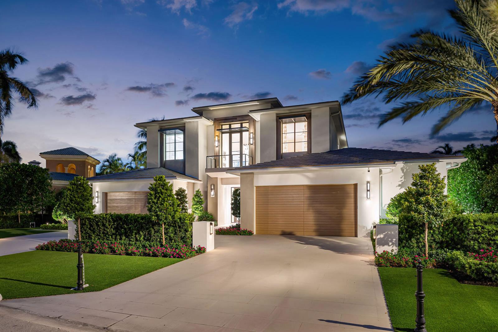 A modern two-story house with a paved driveway, wooden garage doors, and landscaped front yard — 471 Royal Palm Way, Boca Raton FL 33432, BOCA RATON, FL