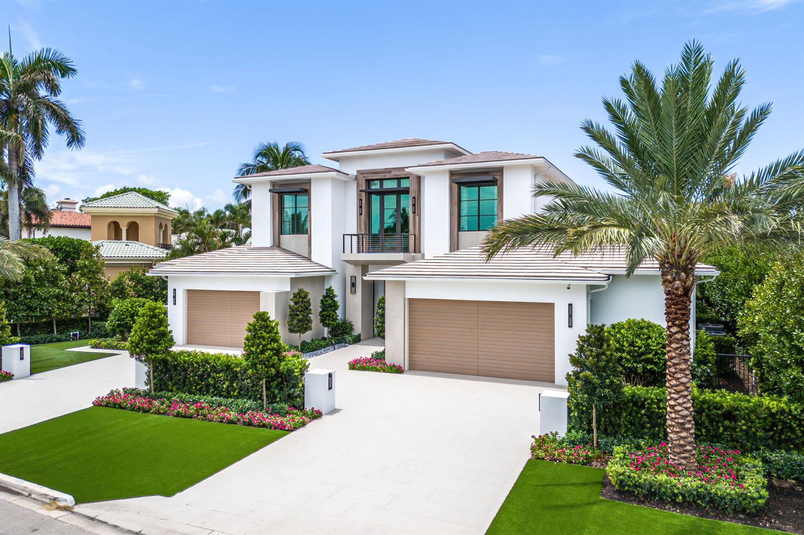 A two-story modern house with a three-car garage, palm trees, and manicured landscaping — 471 Royal Palm Way, Boca Raton FL 33432, BOCA RATON, FL