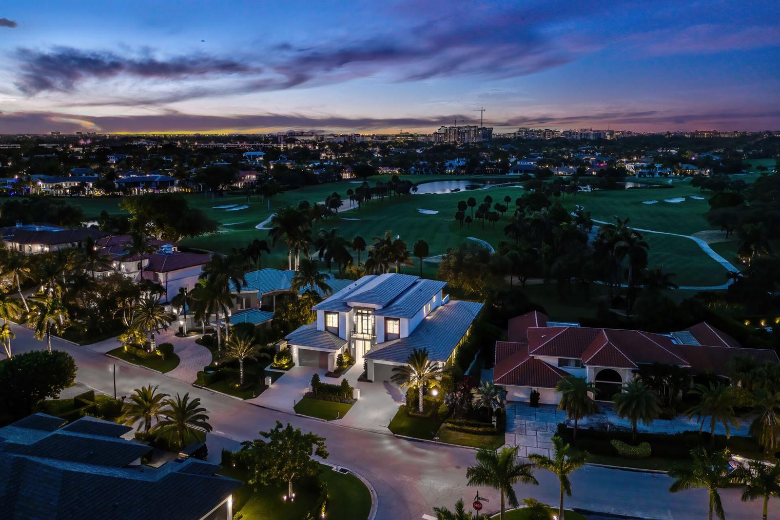 An aerial view of a modern two-story house at dusk overlooking a golf course — 471 Royal Palm Way, Boca Raton FL 33432, BOCA RATON, FL