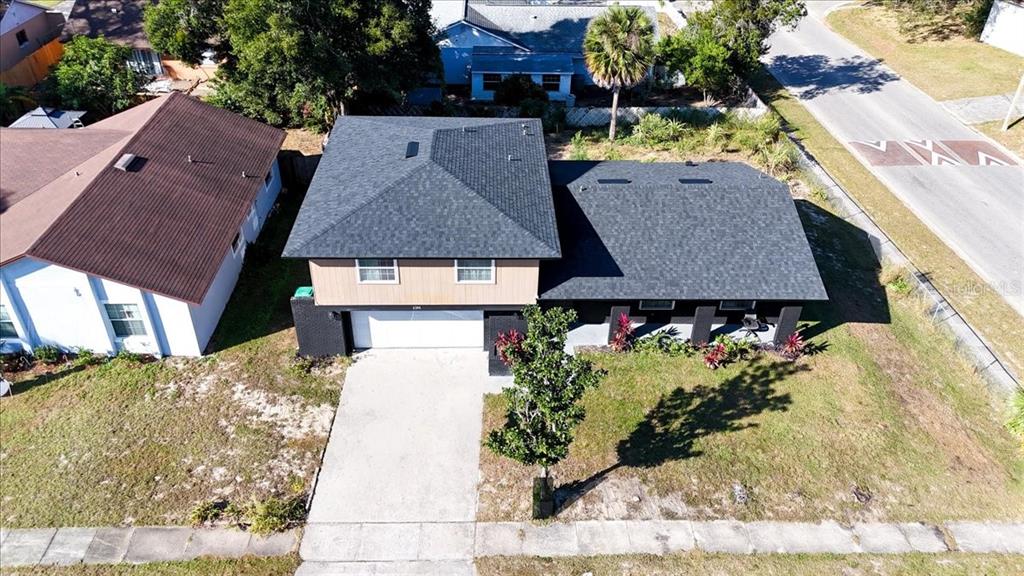 An aerial view shows a two-story house with a dark roof and a concrete driveway — 2244 MENOMONEE COURT, ORLANDO, FL