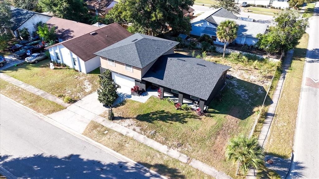 An aerial view shows a two-story house with a dark roof and a large yard — 2244 MENOMONEE COURT, ORLANDO, FL