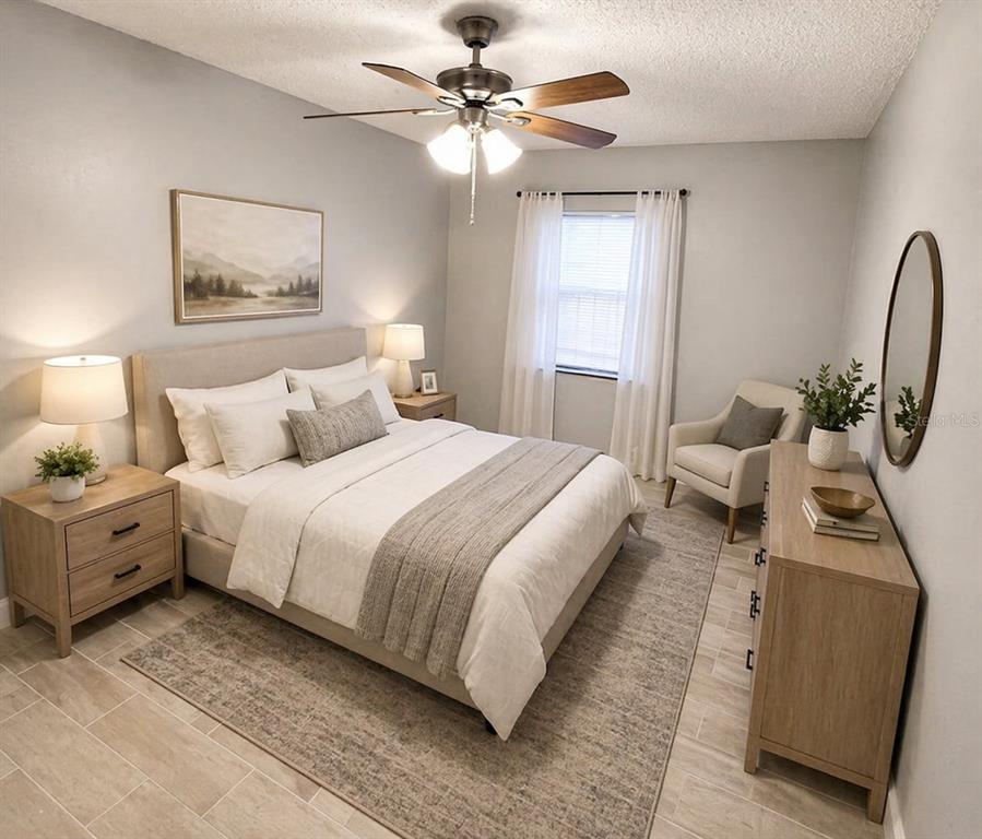A bedroom features a bed with a gray runner, two nightstands, and a dresser — 5228 CHERRY AVENUE UNIT B, SEFFNER, FL