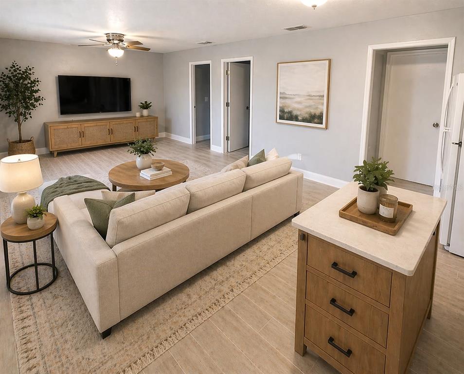 A living room features a beige sofa, a round coffee table, and a wooden media console — 5228 CHERRY AVENUE UNIT B, SEFFNER, FL