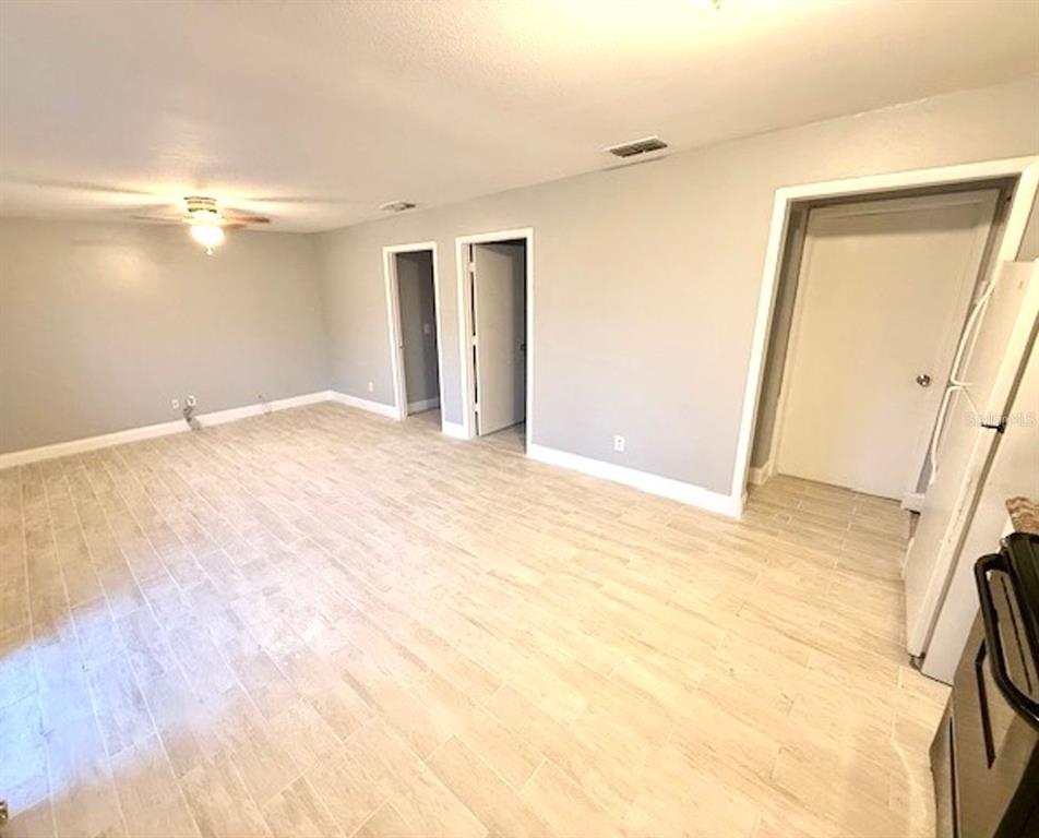 An interior view of a room with light-colored tile flooring and gray walls — 5228 CHERRY AVENUE UNIT B, SEFFNER, FL