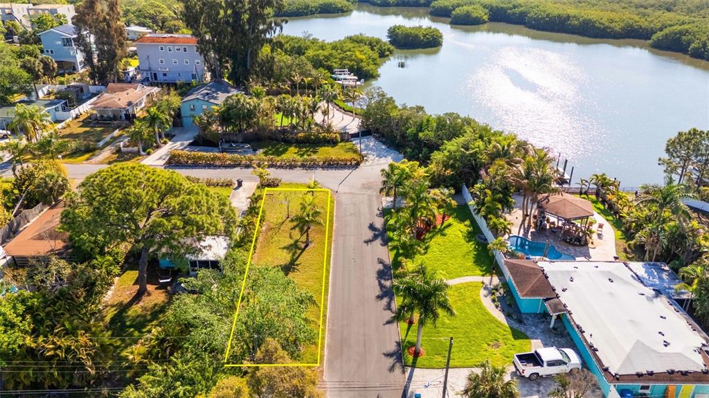 An aerial view shows a vacant rectangular lot outlined in yellow next to a paved road — 44TH STREET S, GULFPORT, FL