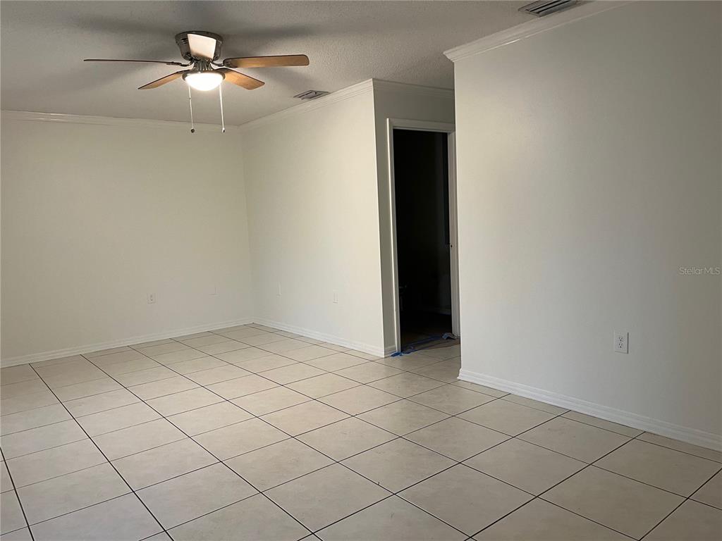 An empty room with white walls, light-colored tile flooring, and a ceiling fan — 3021 W TAMPA BAY BOULEVARD, TAMPA, FL