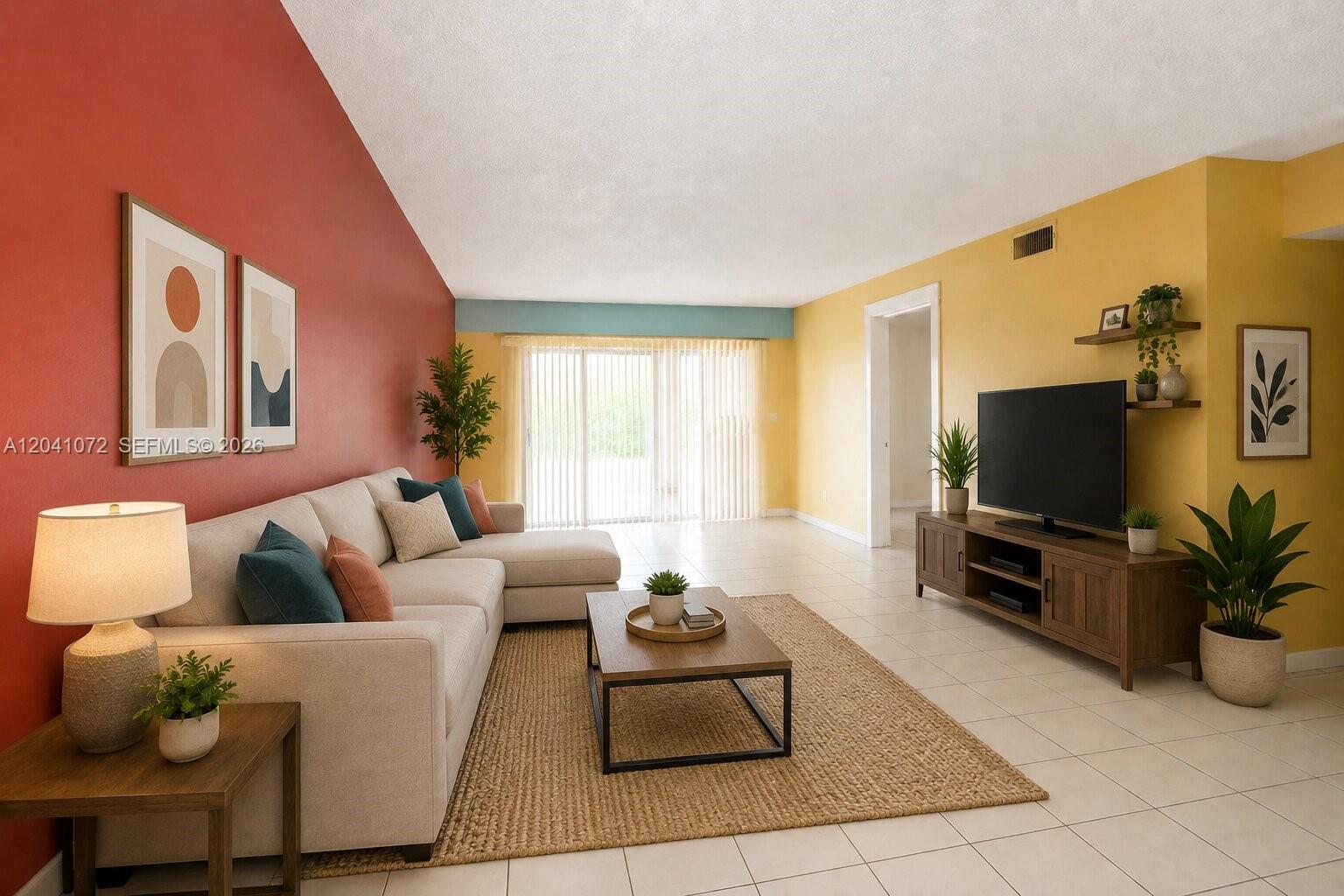 A living room features a beige sectional, a wooden coffee table, and contrasting red and yellow walls — 1975 W 44th Pl # 310, Hialeah FL 33012, HIALEAH, FL