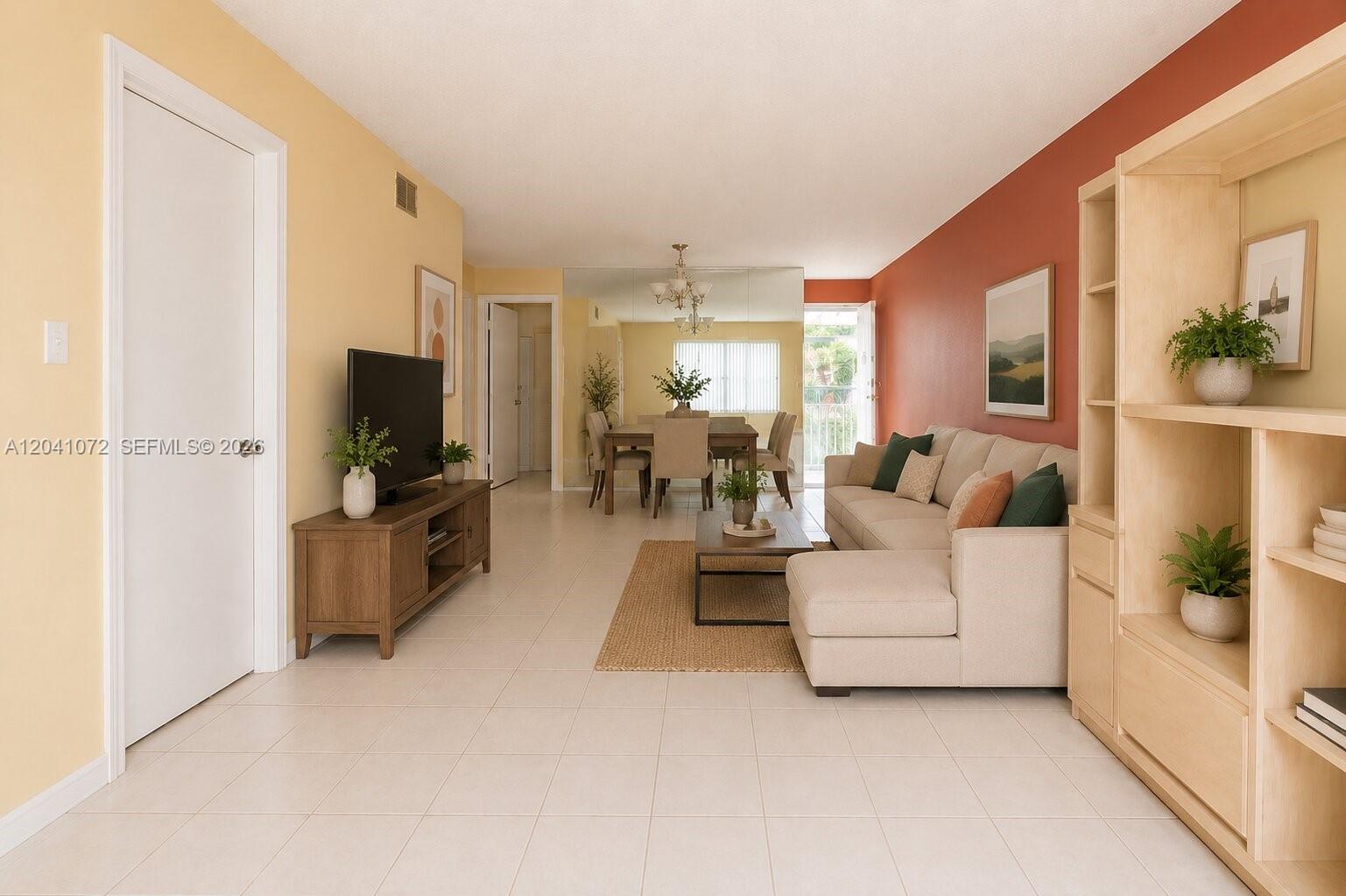 A living room features a beige sofa, wooden media console, and a dining area beyond — 1975 W 44th Pl # 310, Hialeah FL 33012, HIALEAH, FL
